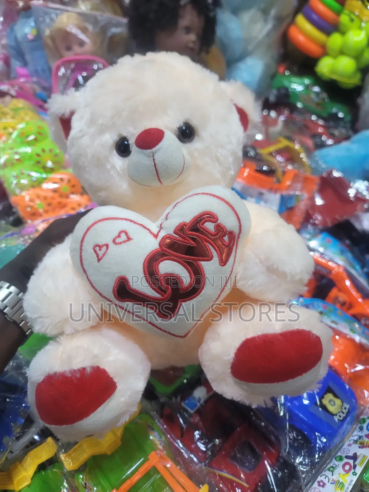 Cream-Colored Plush Teddy Bear Holding a White Heart Pillow