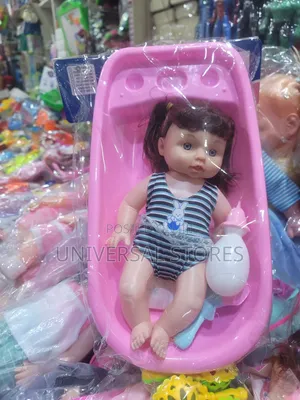 Baby Doll Toy Set Placed Inside a Pink Plastic Bathtub