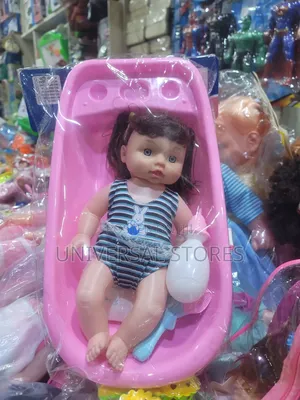 Baby Doll Toy Set Placed Inside a Pink Plastic Bathtub