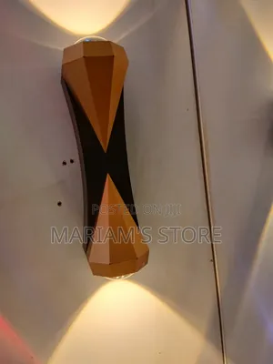 LED Wall Sconce With a Black and Gold/Bronze Finish.