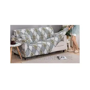 High-Stretch Geometric Print Sofa Slipcover Being Tucked Into Place