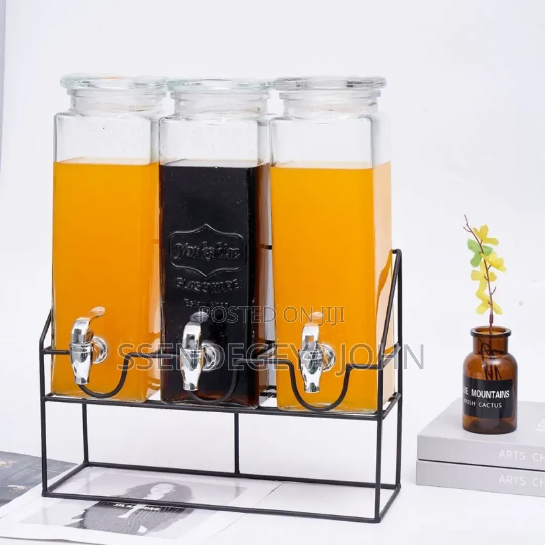 Triple Glass Beverage Dispenser Set With a Metal Stand.
