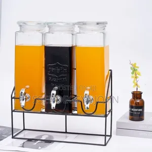 Triple Glass Beverage Dispenser Set With a Metal Stand.