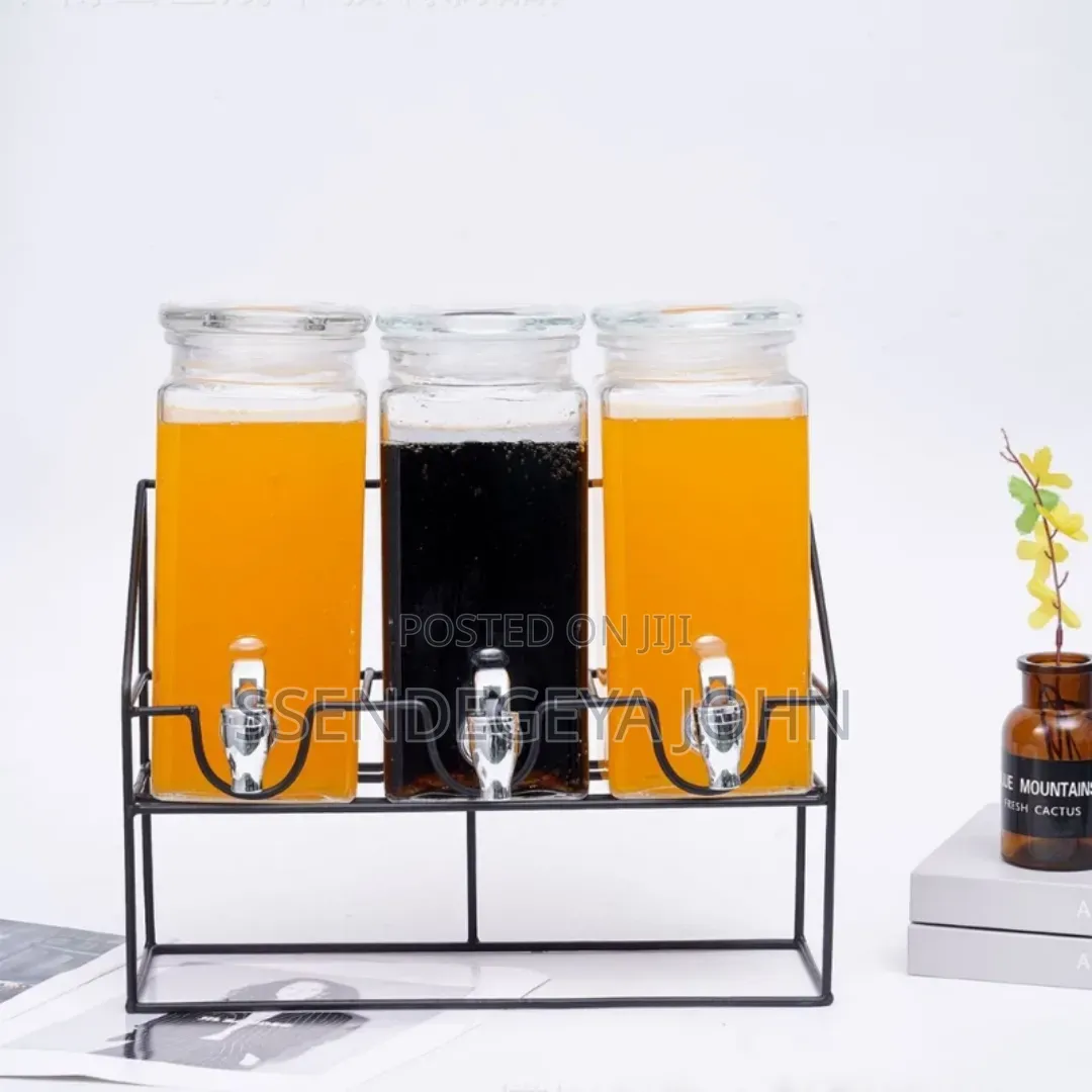 Triple Glass Beverage Dispenser Set With a Metal Stand.