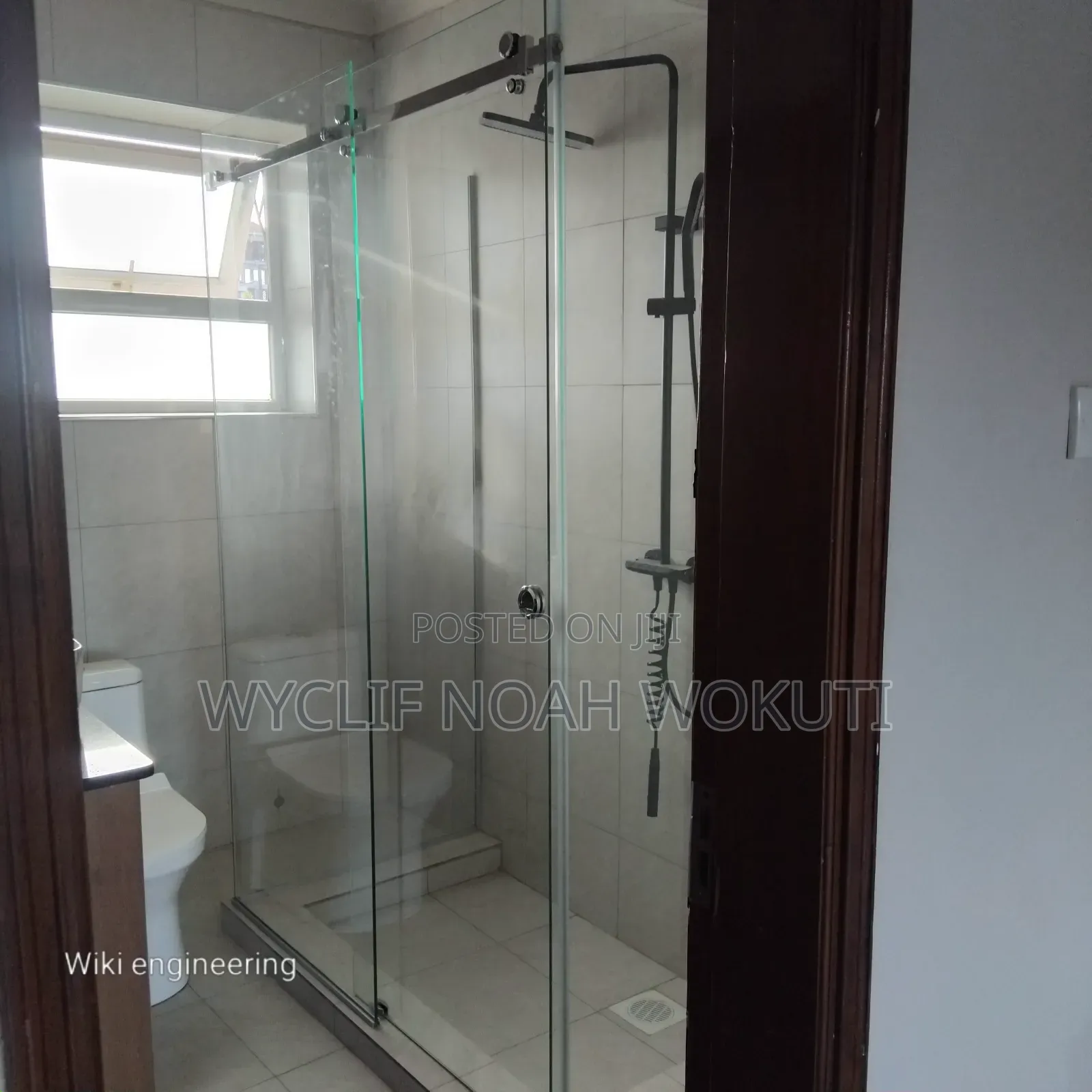 A Clear Shower Cabin With a Sliding Shutter