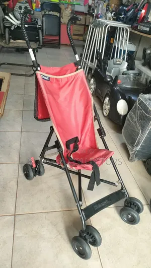 UK Used Lightweight Red Kolcraft Travel Stroller.