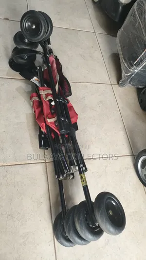 UK Used Lightweight Red Kolcraft Travel Stroller.