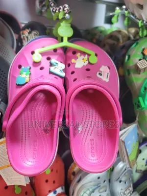 Vibrant Hot-Pink Crocs Clogs Decorated With Playful Shoe Charms