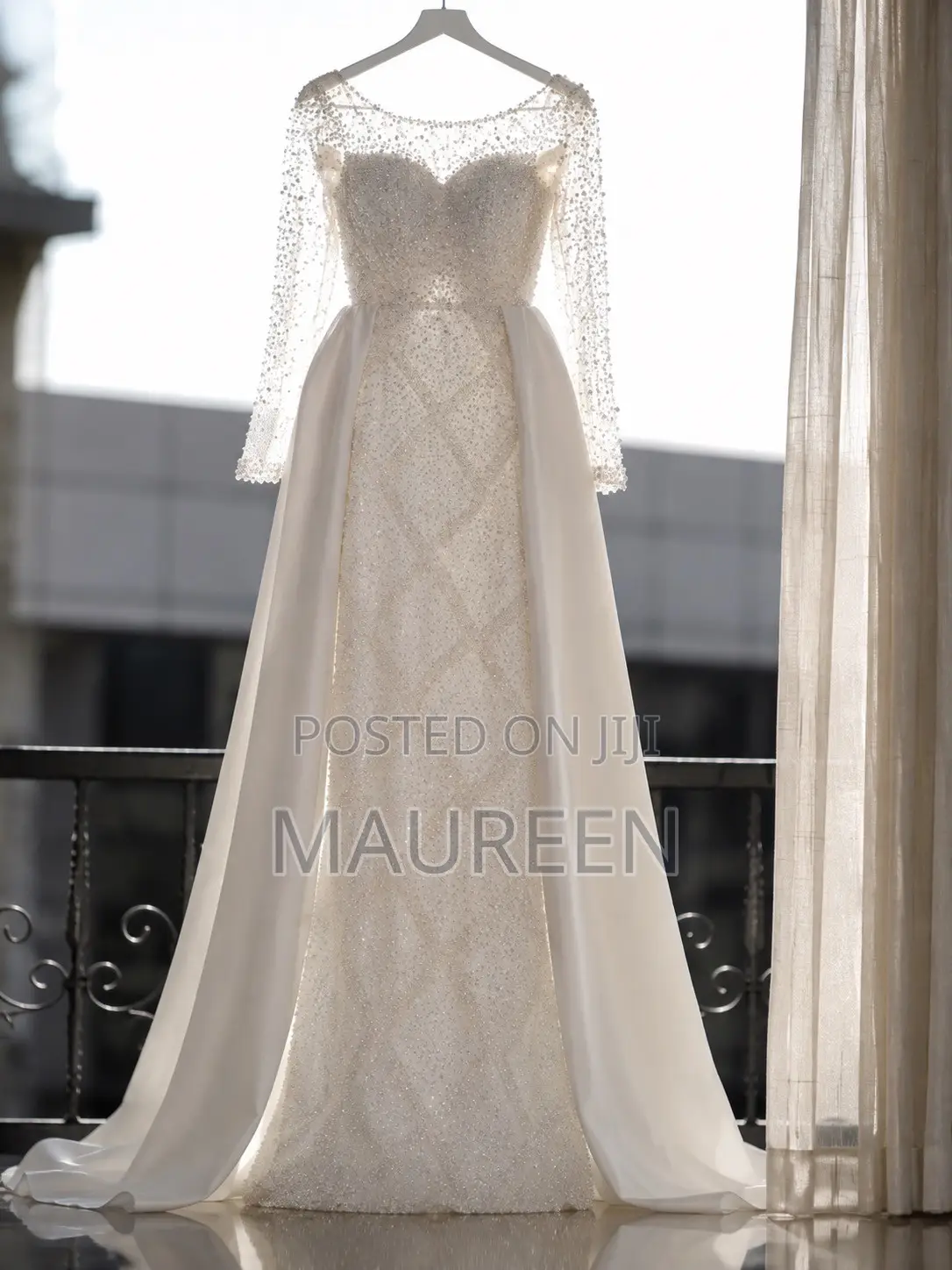 An Elegant White Beaded Bridal Gown With Veil and Satin Skirt