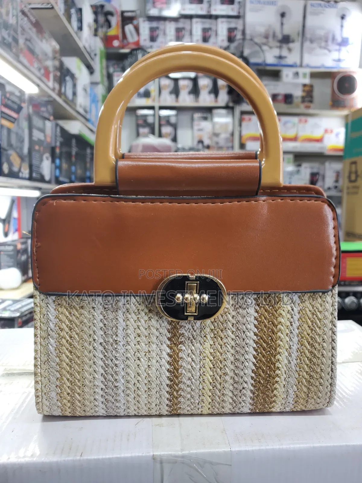 Top-Handle Handbag Featuring a Woven Straw Base in Earthy Tones