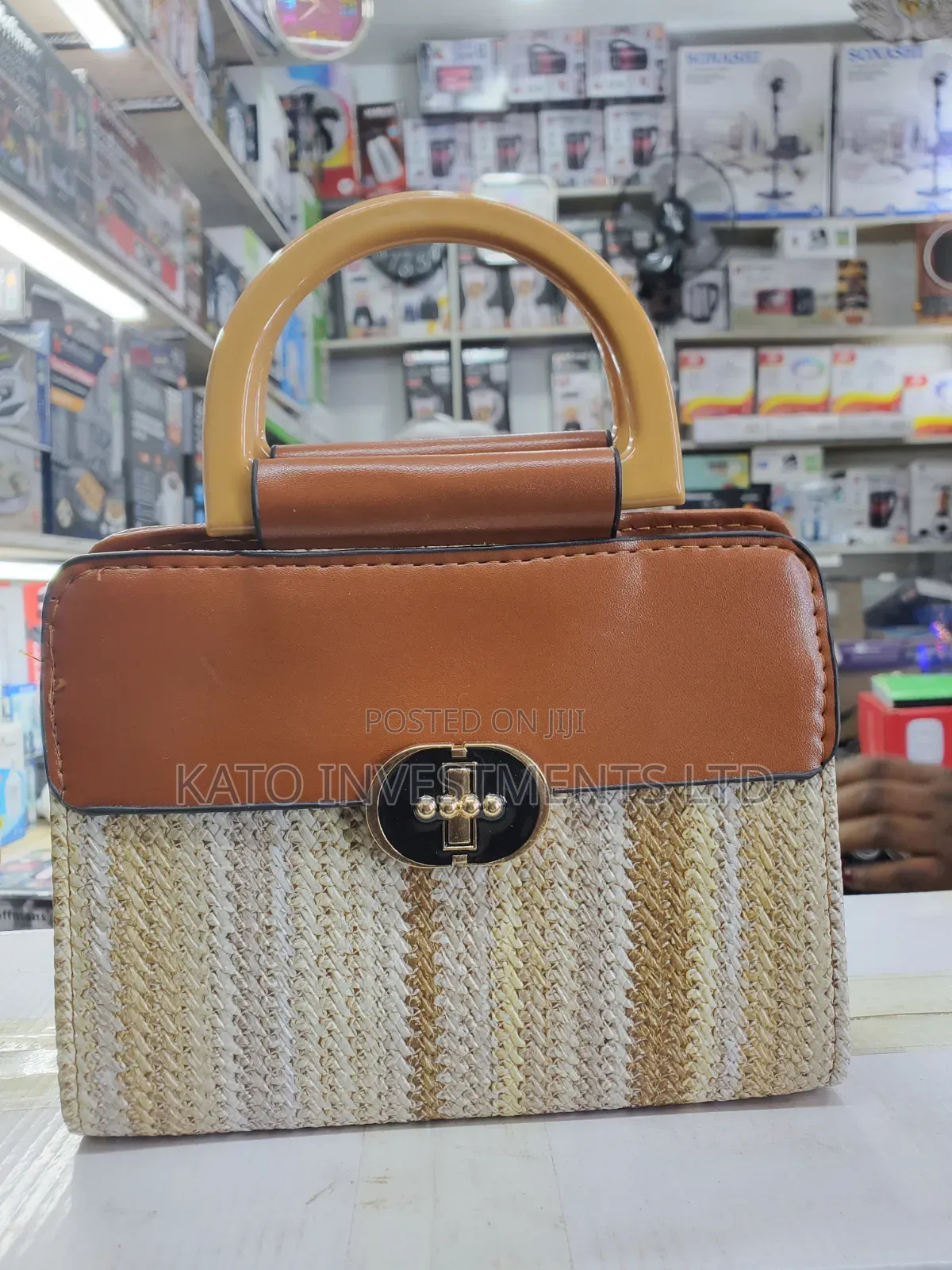 Top-Handle Handbag Featuring a Woven Straw Base in Earthy Tones