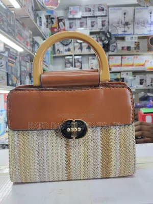 Top-Handle Handbag Featuring a Woven Straw Base in Earthy Tones