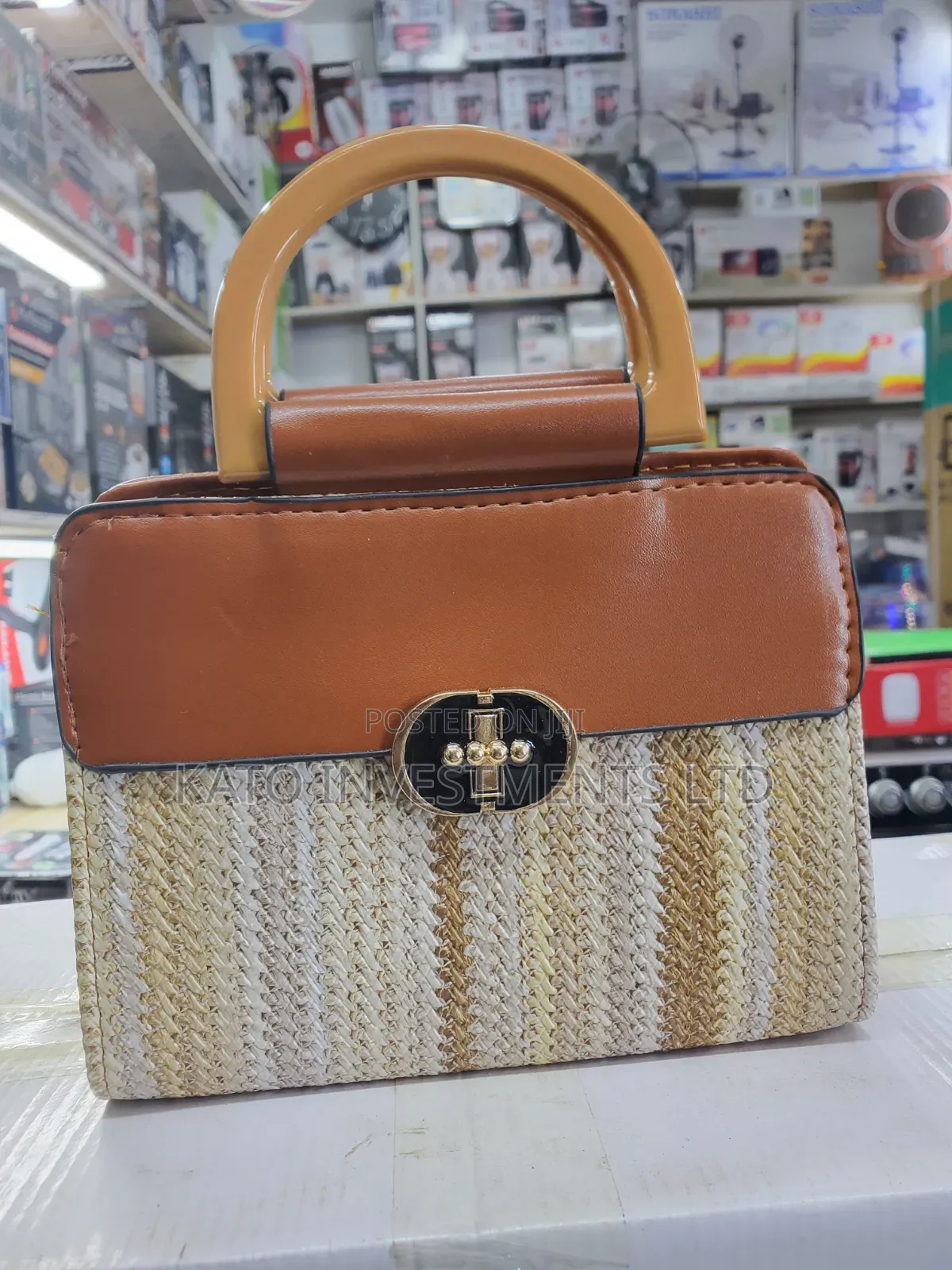 Top-Handle Handbag Featuring a Woven Straw Base in Earthy Tones