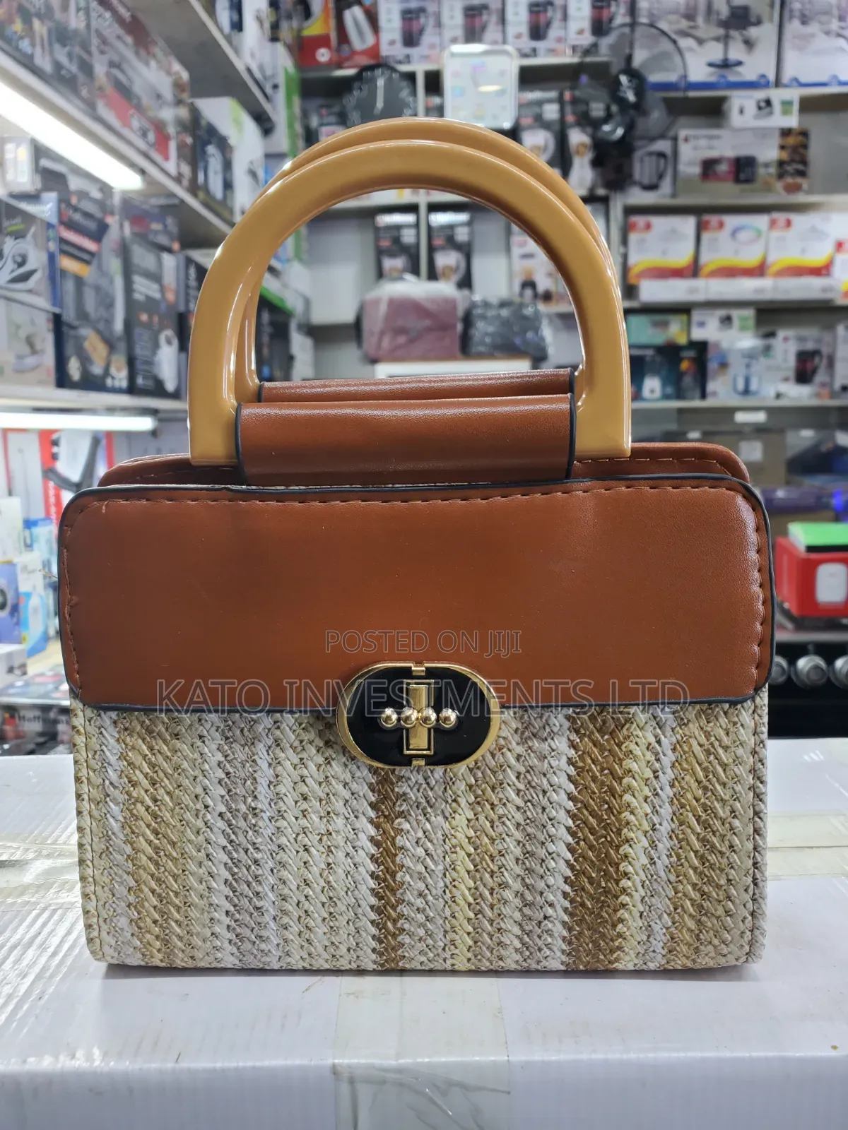 Top-Handle Handbag Featuring a Woven Straw Base in Earthy Tones
