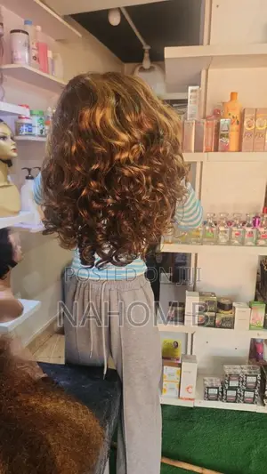 Copper-Toned Curly Hairstyle With Tight, Textured Ringlets.