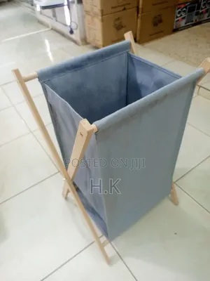 Foldable Laundry Basket With a Fabric Bag and Wooden Stand.