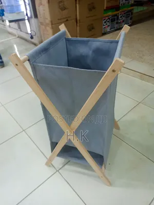 Foldable Laundry Basket With a Fabric Bag and Wooden Stand.