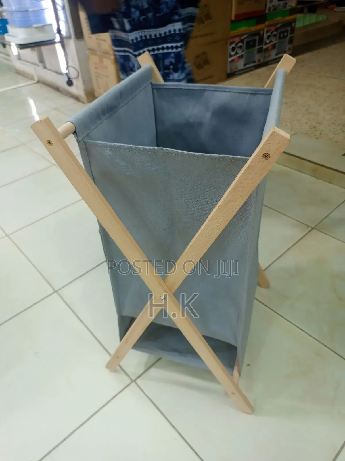 Foldable Laundry Basket With a Fabric Bag and Wooden Stand.
