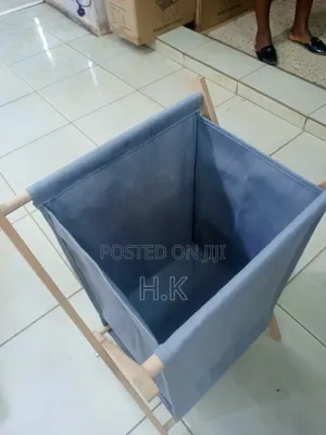 Foldable Laundry Basket With a Fabric Bag and Wooden Stand.