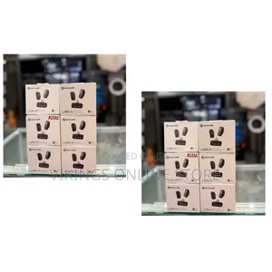 Hollyland Lark A1 Wireless Microphone System Stacked on a Glass Shelf.