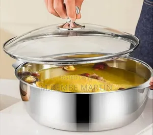 Stainless Steel Hot Pot With a Transparent Glass Lid and Side Handles.