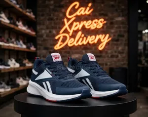 Navy Blue and White Reebok Trainer Sneakers.
