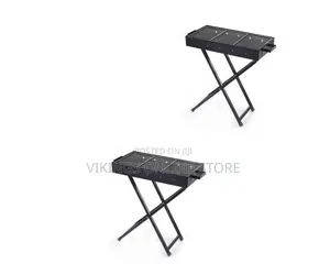 A Portable Folding Charcoal BBQ Grill With a Black Rectangular