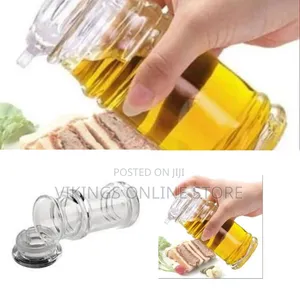 A Transparent Acrylic Oil and Vinegar Dispenser Bottle Used in Kitchen